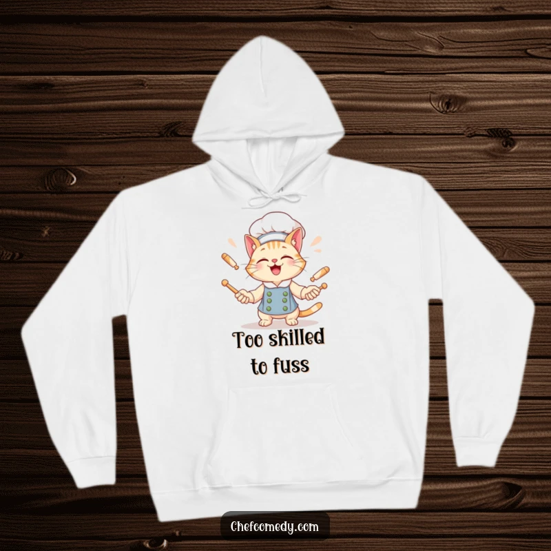 Funny Cat Chef Hoodie: A giggling cat with a wide grin juggles rolling pins, offering warmth and humor.