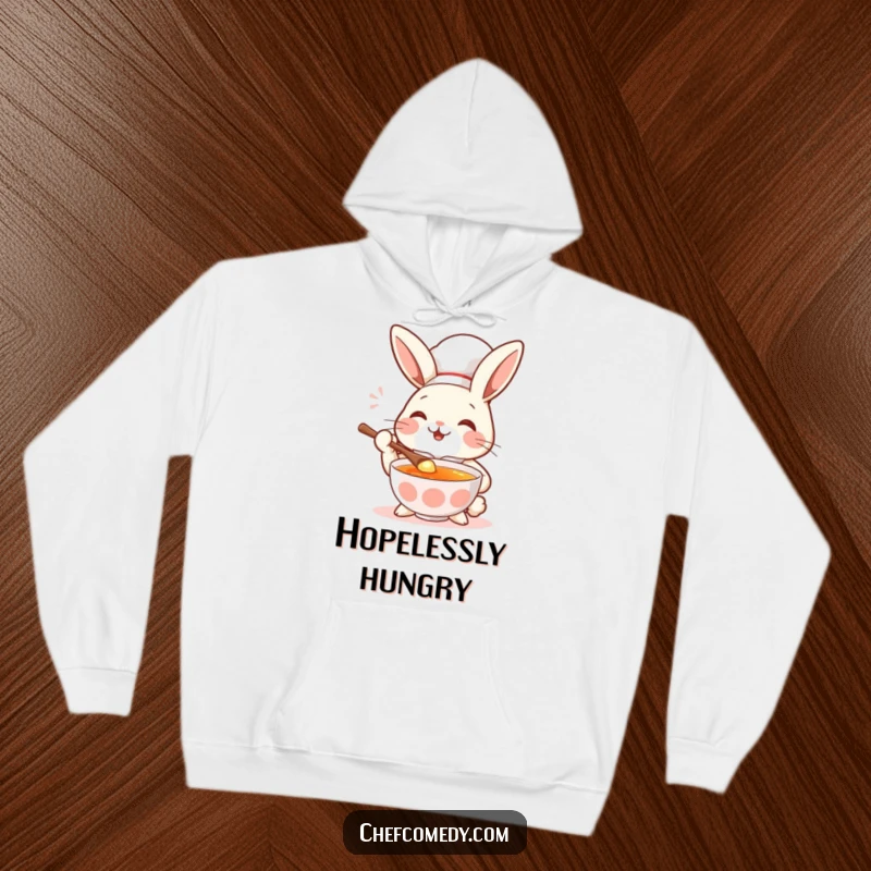 Funny rabbit chef savoring soup with a spoon and a huge smile, cozy and humorous hoodie.