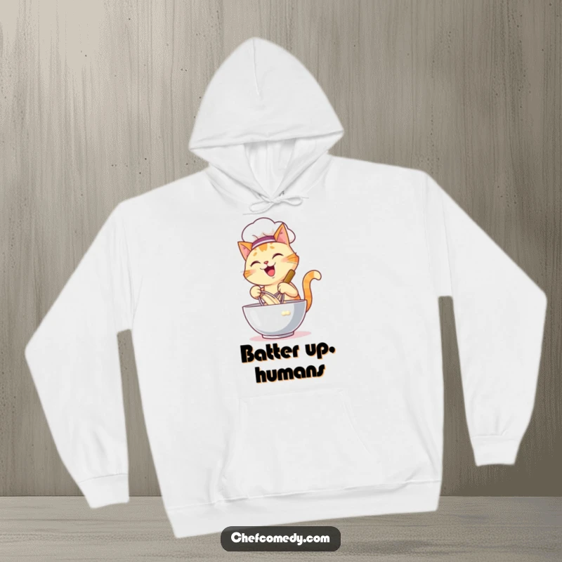 Funny hoodie featuring a happy cat chef energetically whisking batter in a large bowl, blending cozy comfort with kitchen action.