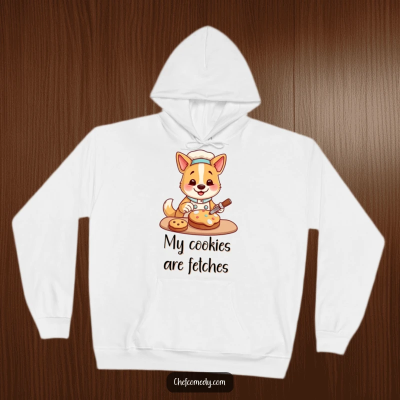 Funny hoodie with a happy dog chef character decorating a cookie, perfect for cozy baking and a humorous statement.