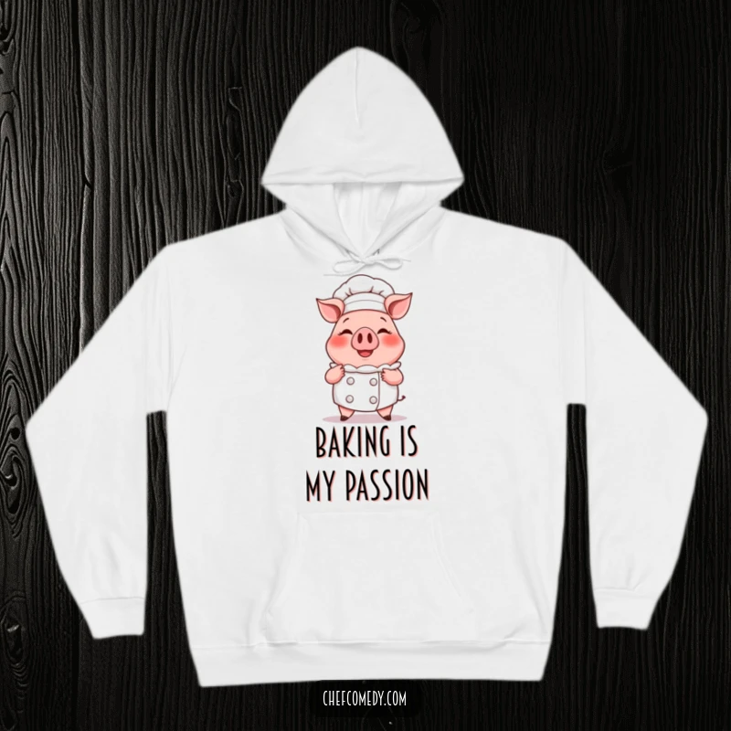 Funny hoodie featuring a smiling cartoon pig chef proudly presenting a delicious, oversized steaming cupcake, offering warmth and charm.