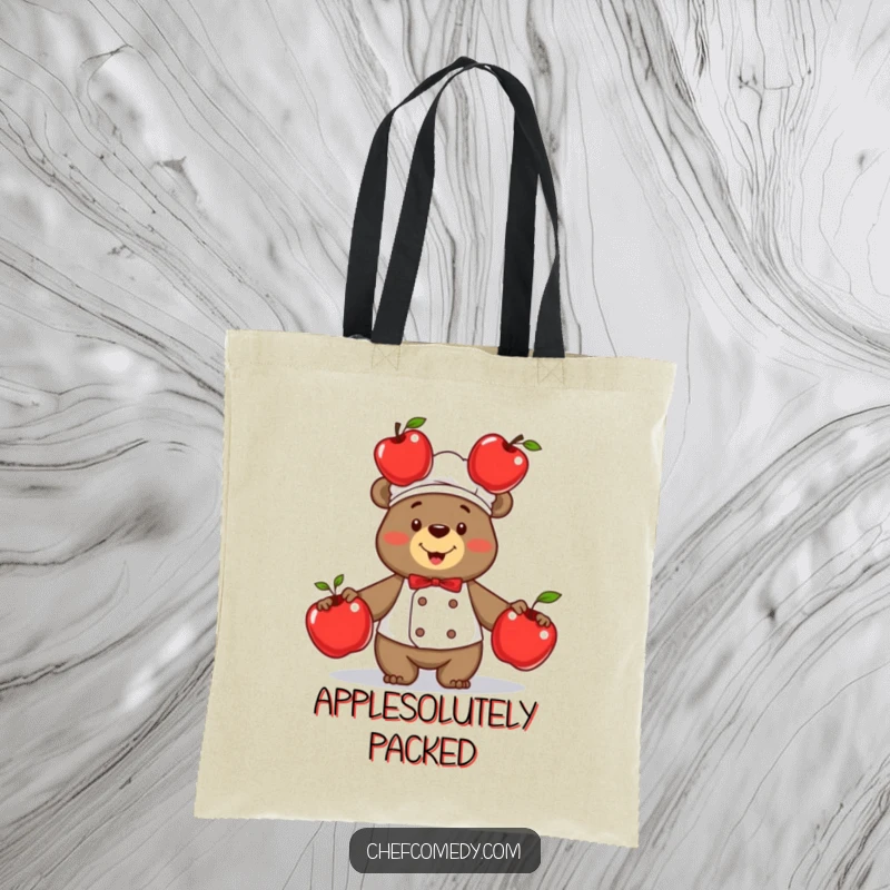 Funny bear chef expertly juggling three vibrant red apples, a humorous and practical tote bag for grocery shopping or daily use.
